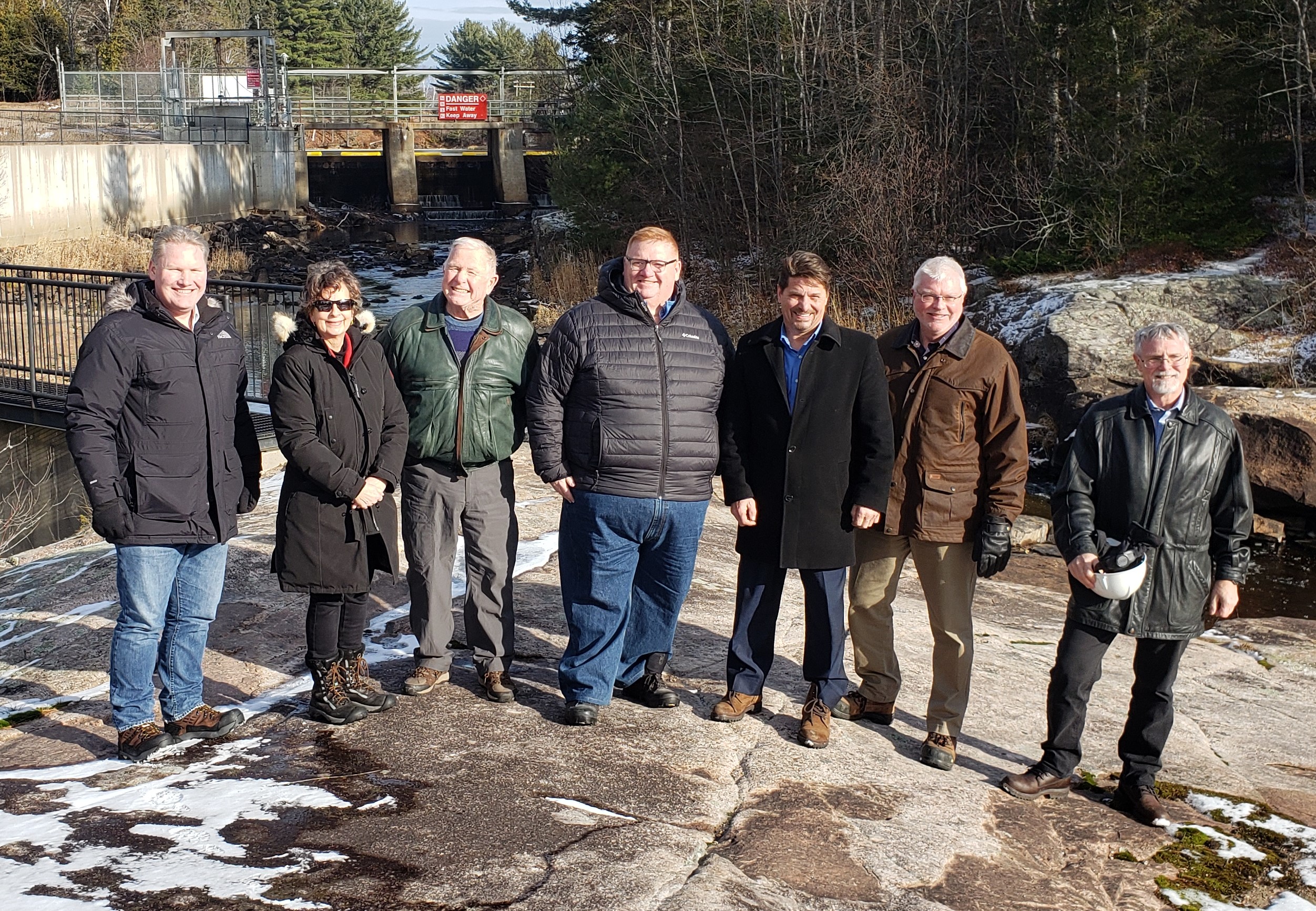 Minister Smith and guests standing in front of South River dam